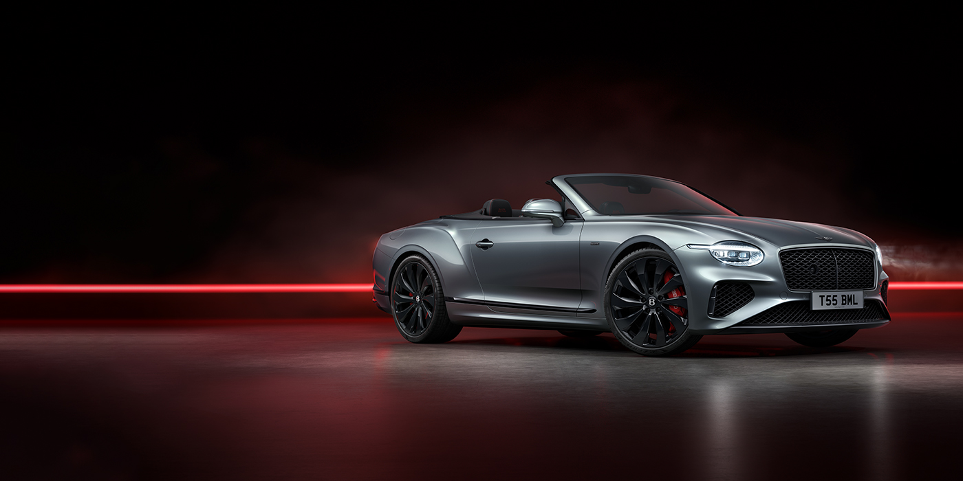 Bentley Suomi Bentley Continental GTC Black Edition convertible front three quarters in Hallmark silver against a dark grey and red background