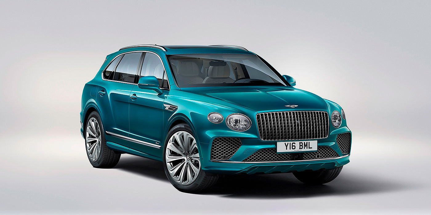 Bentley Suomi Bentley Bentayga Azure front three-quarter view, featuring a fluted chrome grille with a matrix lower grille and chrome accents in Topaz blue paint.