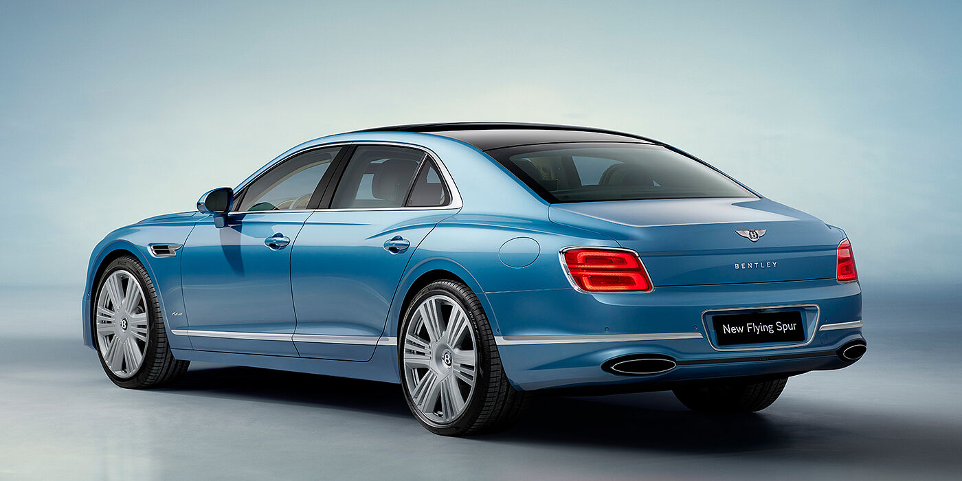 Bentley Suomi New Bentley Flying Spur Azure sedan rear view in Light windsor blue by Mulliner paint with 22 inch Azure wheels and chrome exterior details