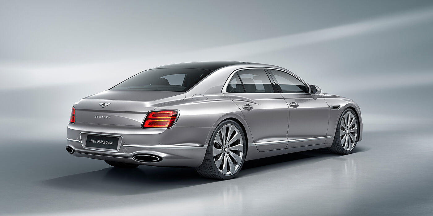 Bentley Suomi New Bentley Flying Spur sedan rear view in Silverlake paint with ten spoke wheels and chrome matrix grille
