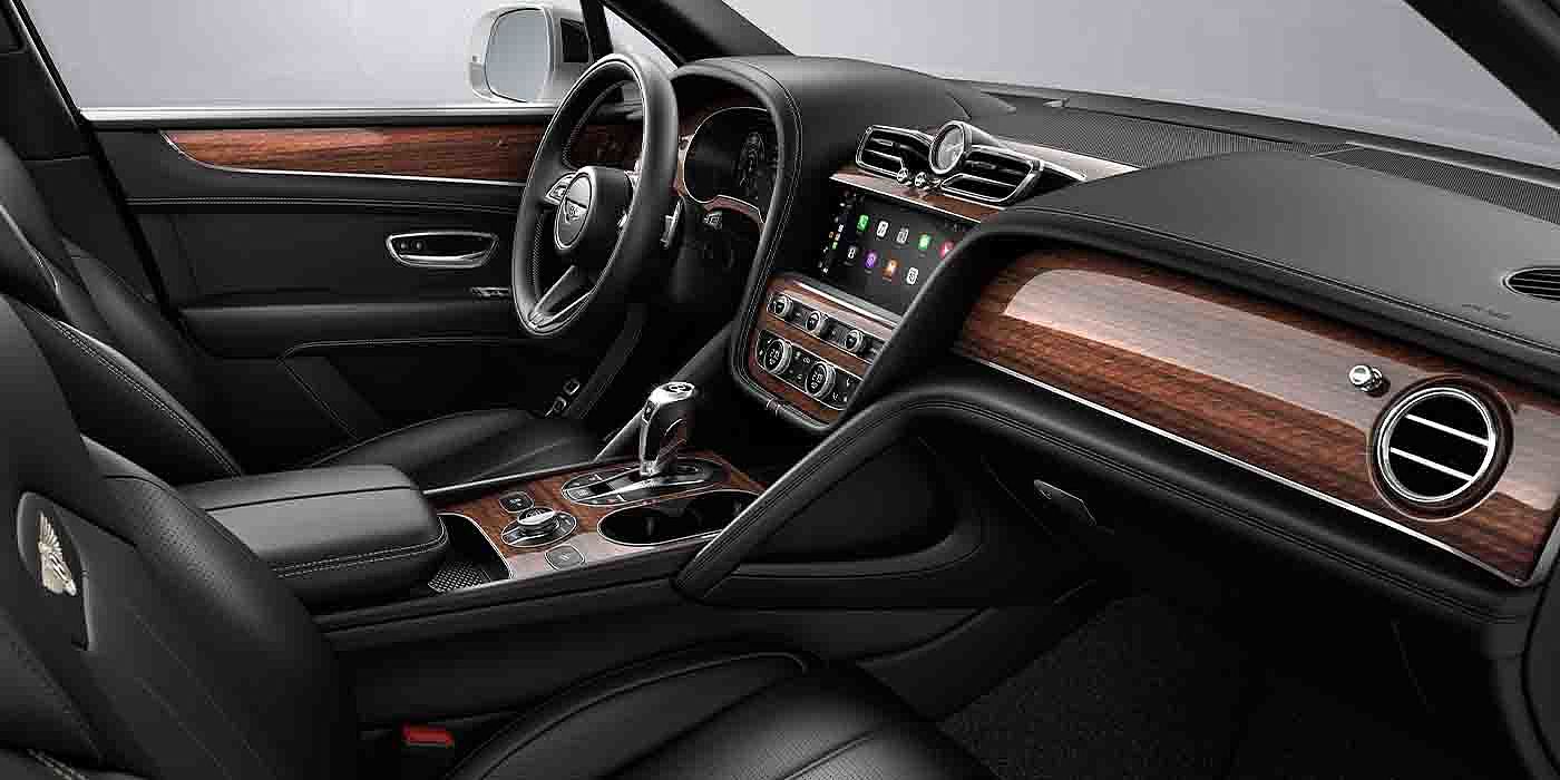 Bentley Suomi Bentley Bentayga EWB interior with a Crown Cut Walnut veneer, view from the passenger seat over looking the driver's seat.