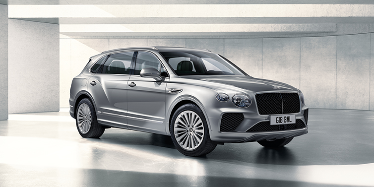 Bentley Suomi Bentley Bentayga Extended Wheelbase SUV front three quarter in Moonbeam paint with a grey background